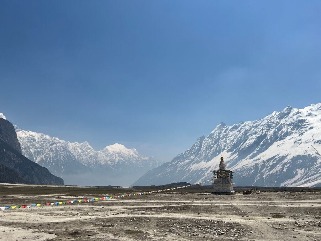 Majestic view of snowcapped Himalayas and a stupa under a clear blue sky in Nepal. Nepal Police Clearance Certificate